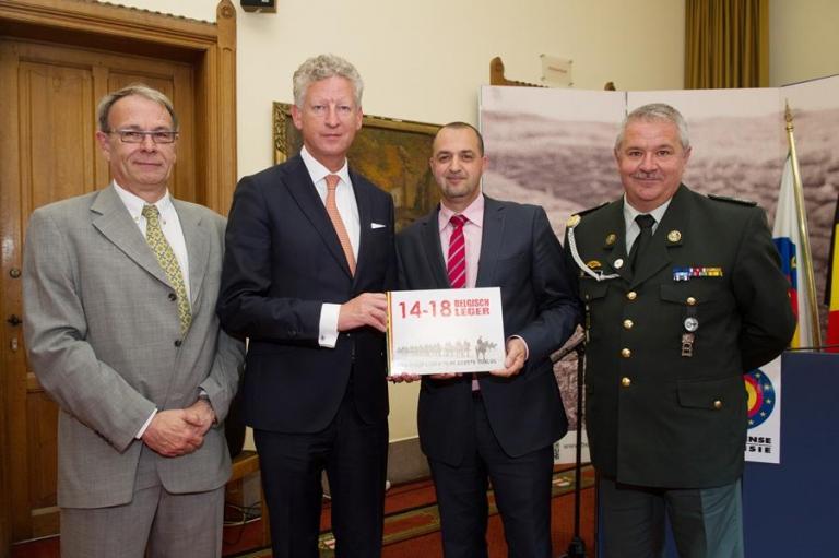 De makers van het boek bij de minister: majoor Rob Troubleyn, eerste sergeant-chef Malek Azoug en adjudant Patrick Brion.